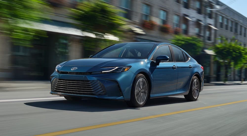 A blue 2025 Toyota Camry XLE is shown from the front at an angle.